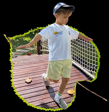 Child walking on wooden bridge