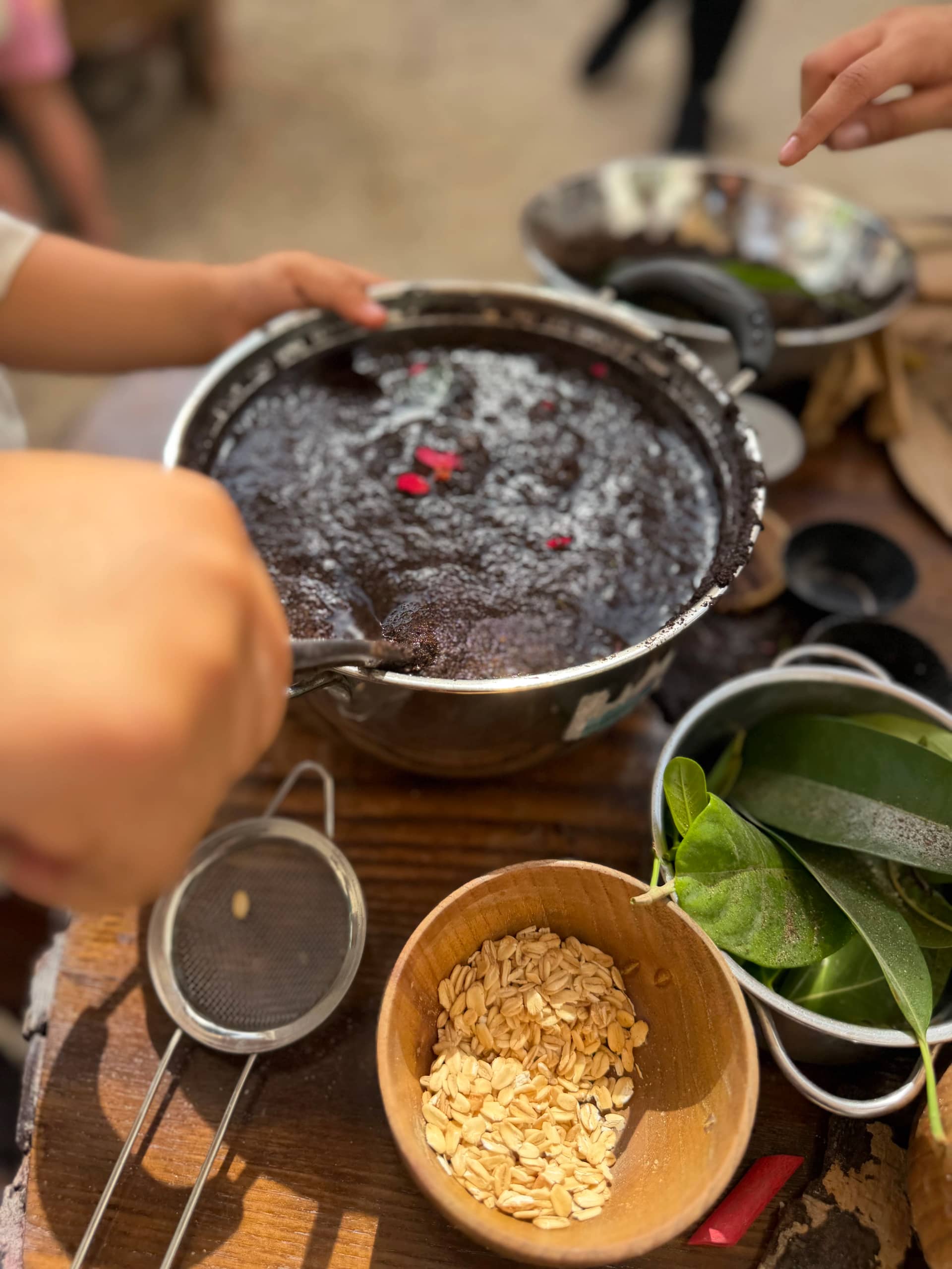 Children mud kitchen cooking activity