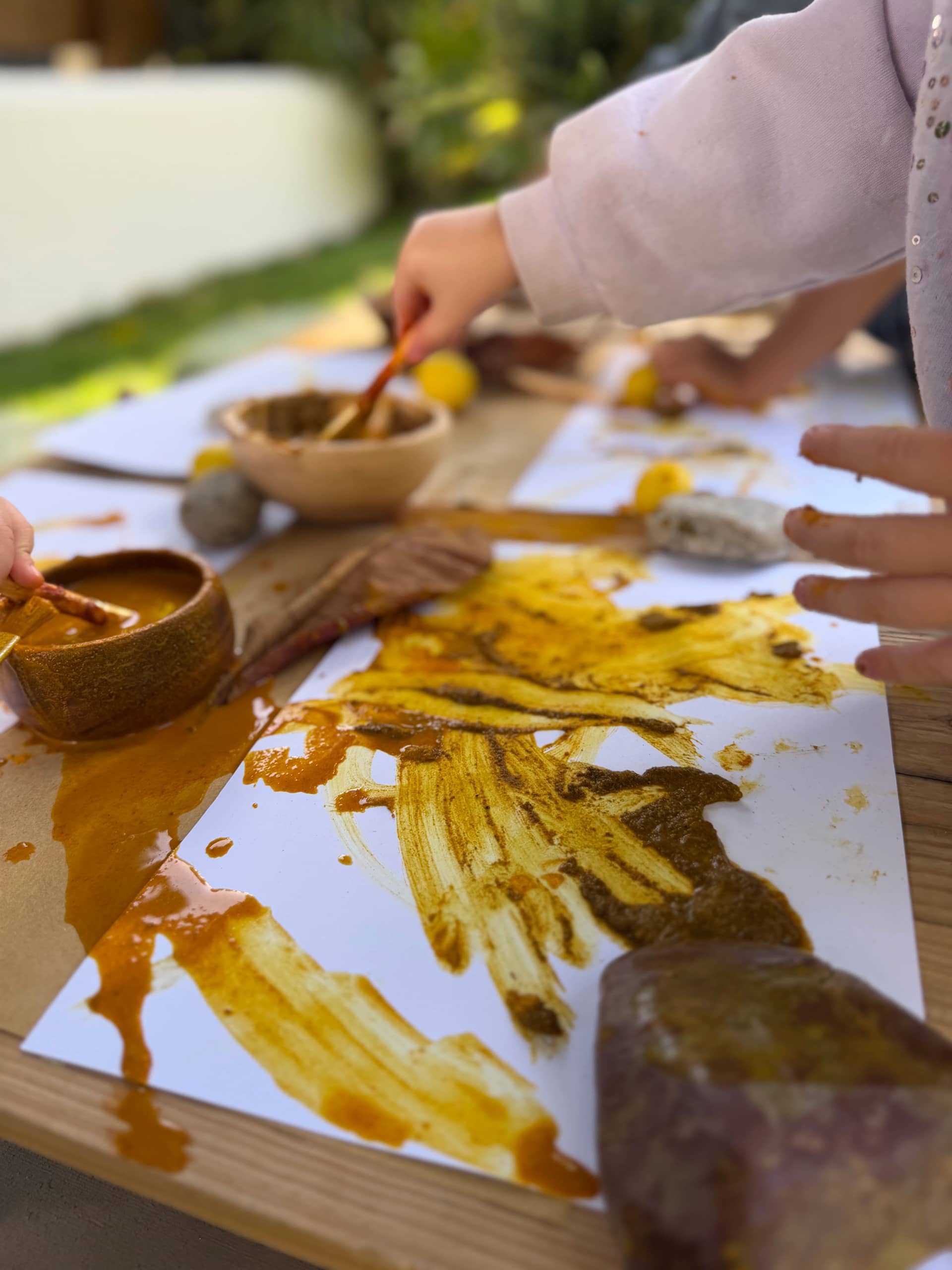 Children painting with natural earth pigments